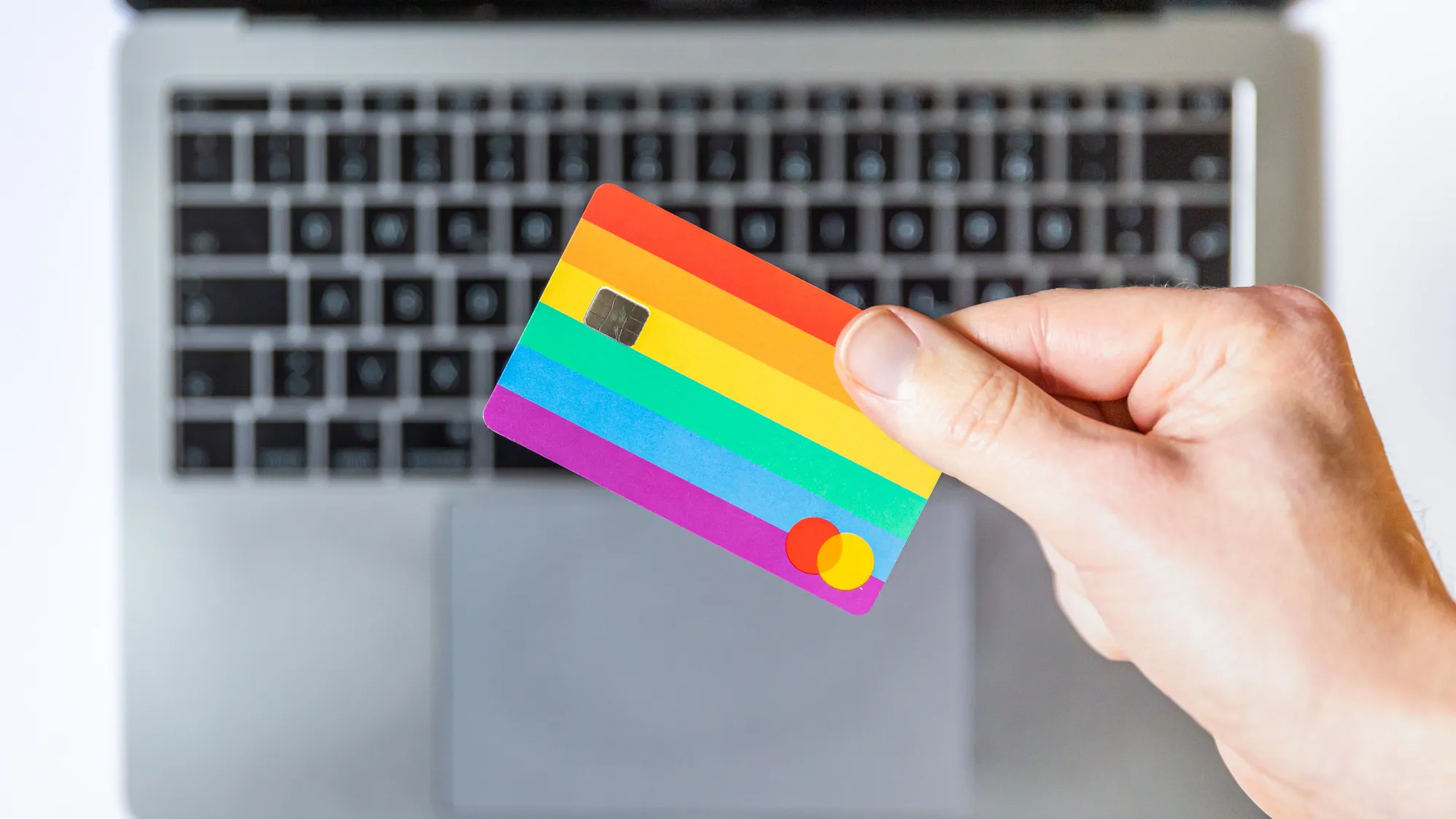 colorful credit card in front of a macbook