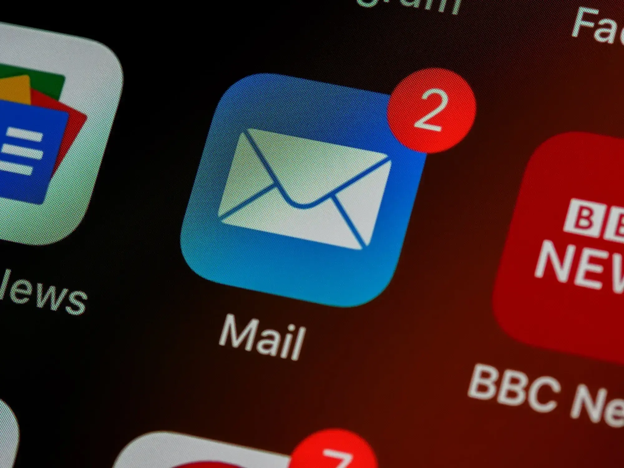Close Up from an iPhone Screen showing the Mail Icon with a red dot and a 2 in it. 