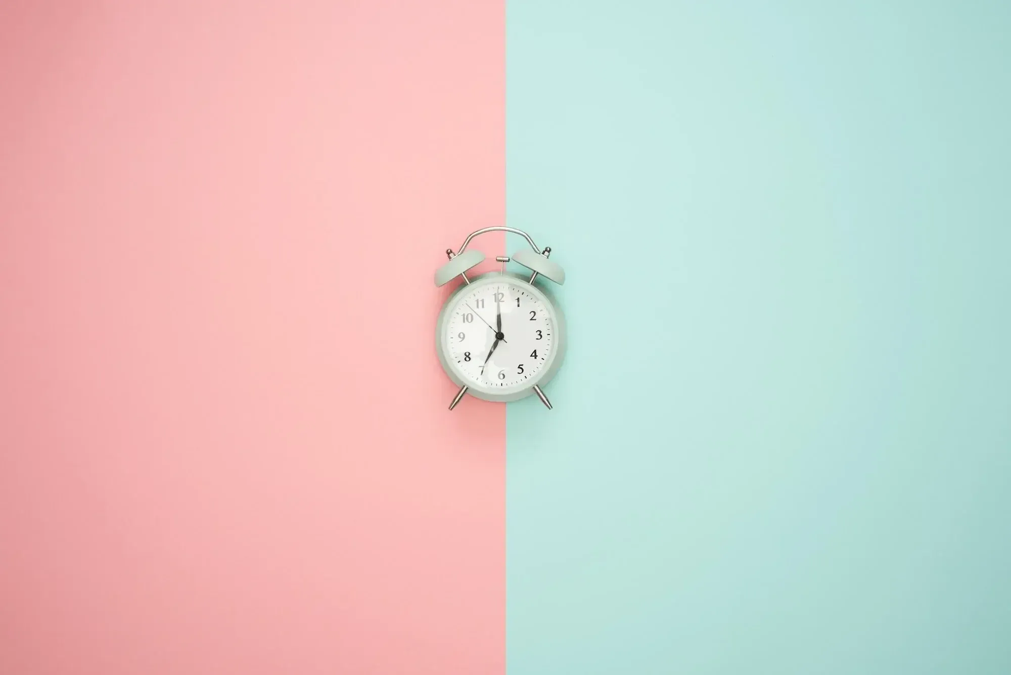 Blue clock on a pastel background