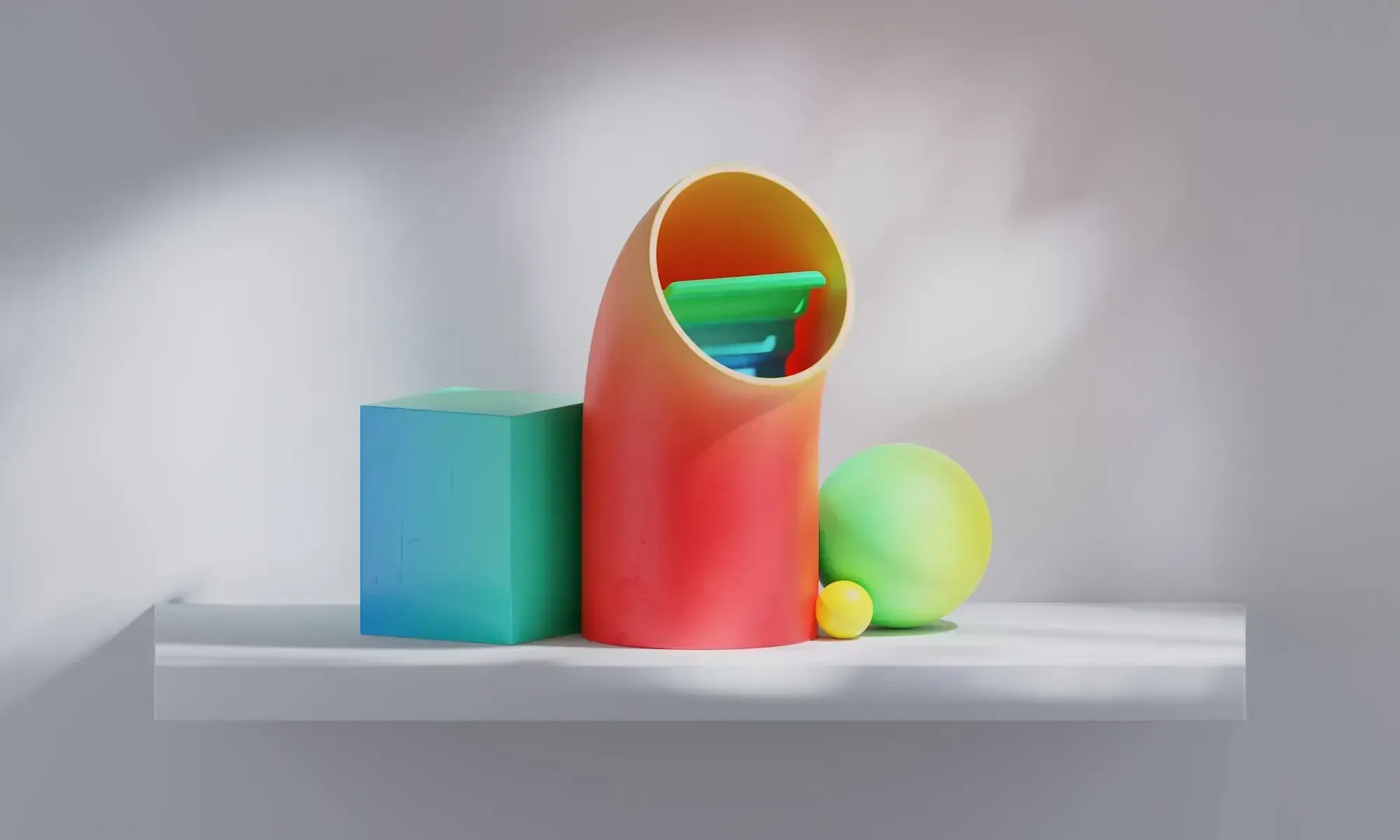 Blue cube, orange tube, yellow small ball and green large ball in 3D on a grey background.